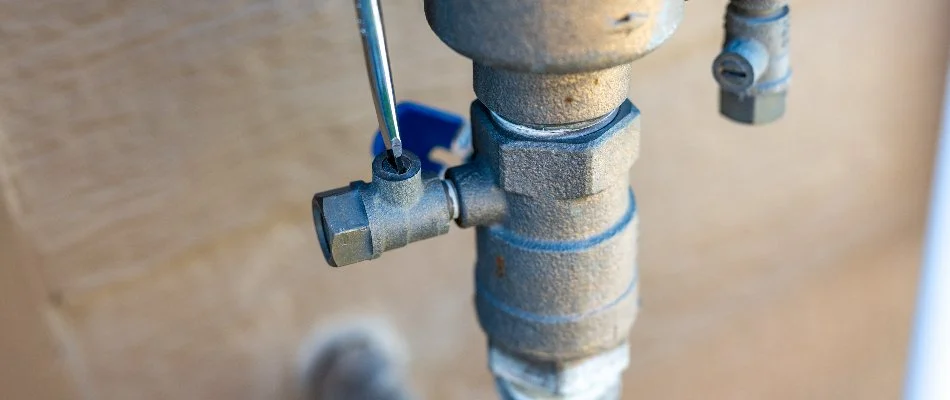 Opening the valve of an irrigation system for an irrigation startup service in Cary, NC.