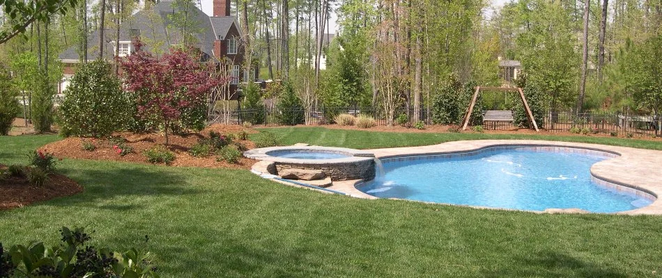 Landscape with green lawn and pool in Cary, NC.